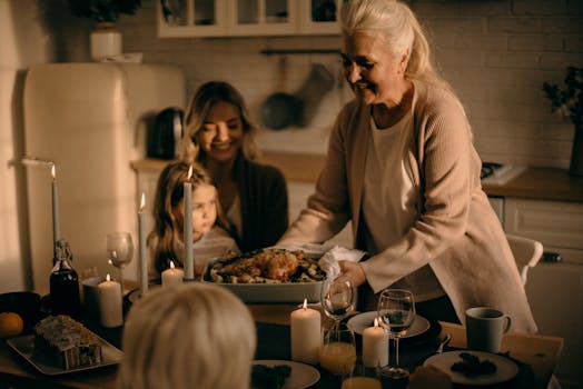 Fa La La and Everything A grandmother serves a festive turkey dinner to family gathered around a warmly lit table.